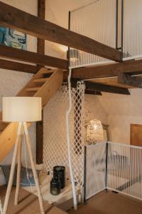 a loft bed with a lamp in a room at Flusshaus BnB Alicudi in Brugg