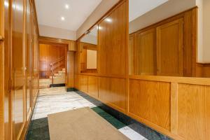 a hallway with wood paneling and a staircase at Plaza del Carmen in Gijón