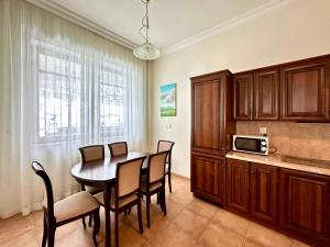 a kitchen and dining room with a table and chairs at Slunecni Lazne Apartments in Karlovy Vary