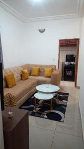 a living room with a couch and a table at Olympus studio 1 in Yaoundé