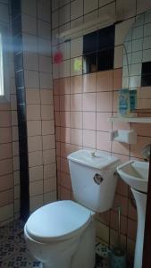 a bathroom with a white toilet and a sink at Olympus studio 1 in Yaoundé