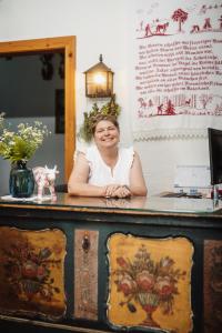 a woman sitting at a desk in a room at Berg- & Seeblick Pfefferbauer in Zell am See