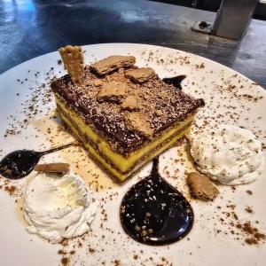 a piece of cake on a plate with twooops of ice cream at Pensión Casa Miguel in Artedo