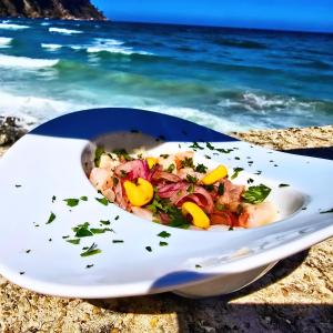 a bowl of food on a plate on the beach at Pensión Casa Miguel in Artedo