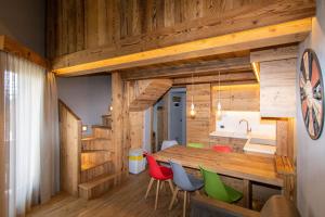 a kitchen and dining room with a table and chairs at Livigno Chalets in Livigno