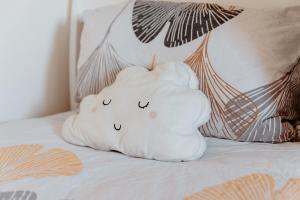 a white pillow sitting on top of a bed at Apartman Deja vu in Livno