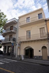 a large building with balconies on a city street at Agorà Luxury Experience in Zafferana Etnea