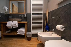 a bathroom with a sink and a toilet and a mirror at Livigno Chalets in Livigno +82 photos