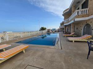 a swimming pool on the roof of a building at Soltan palace in Qaryat Wādī ‘Abbādī 1