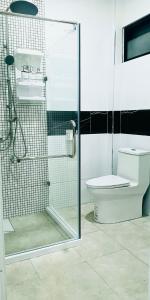 a bathroom with a shower and a toilet and a sink at Leelavadee Villa Sea Views in Tha Sala +110 photos