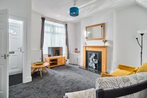 a living room with a couch and a fireplace at Craigs Nook in Darlington