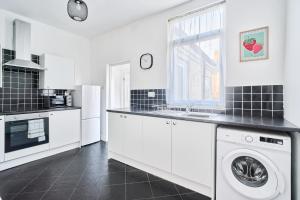 a kitchen with a washer and dryer in it at Craigs Nook in Darlington +1 photo