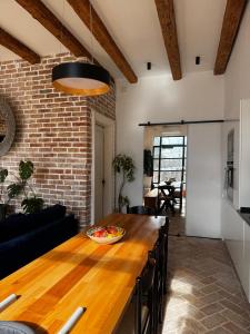 a kitchen and dining room with a wooden table at Exceptional Home-5 min from Porto Montenegro Tivat in Tivat