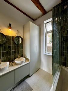 a bathroom with two sinks and a shower at Exceptional Home-5 min from Porto Montenegro Tivat in Tivat +23 photos