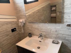a bathroom with a sink and a mirror and a phone at Cascina Concetta in Pizzo +46 photos