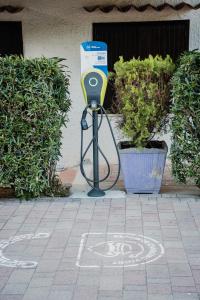 a parking meter with a hose attached to it at Camping & Village Rais Gerbi in Pollina