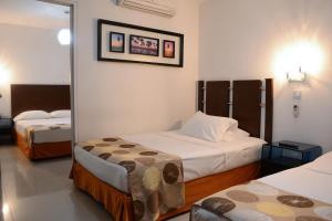 Ένα ή περισσότερα κρεβάτια σε δωμάτιο στο Hotel Calima Real