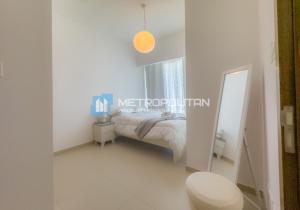 a white bedroom with a bed and a mirror at Gate Tower, 1BR Reem Island, Near Galleria, Abu Dhabi Mall & the City in Abu Dhabi +11 photos