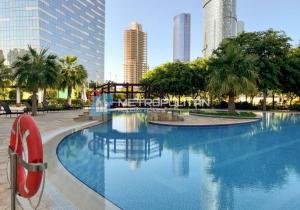 a large swimming pool in a city with tall buildings at Gate Tower, 1BR Reem Island, Near Galleria, Abu Dhabi Mall & the City in Abu Dhabi