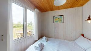a small bedroom with a bed and a window at F67 Ischia, Riviere Towans in Hayle