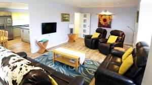 a living room with two couches and a tv at Tigh Na Sith in Aultbea