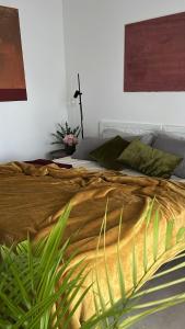a bedroom with a large bed with a plant at Thesan B&B in San Prisco