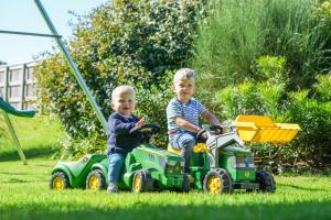 two young boys playing with toy tractors in the grass at Honeysuckle Cottage in Hele +64 photos