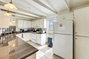 a kitchen with white appliances and a white refrigerator at Work, Explore & Unwind: Greenville Getaway w/ Yard in Greenville