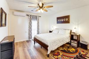 a bedroom with a bed and a ceiling fan at Work, Explore & Unwind: Greenville Getaway w/ Yard in Greenville
