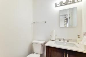 a bathroom with a toilet and a sink and a mirror at Work, Explore & Unwind: Greenville Getaway w/ Yard in Greenville +19 photos