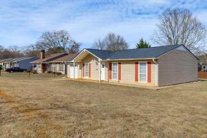 a row of houses on a grass field at Work, Explore & Unwind: Greenville Getaway w/ Yard in Greenville