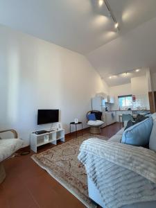 a living room with a couch and a flat screen tv at Casa do Profeta in Porto Santo