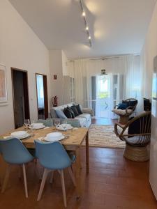 a living room with a wooden table and chairs at Casa do Profeta in Porto Santo