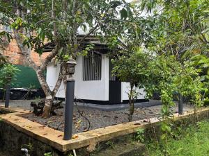 a street light in front of a house with trees at Dilco Villa Ahangama in Ahangama