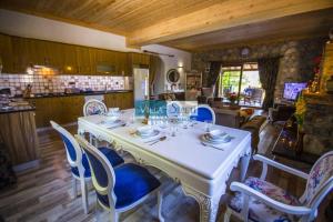 a dining room with a white table and chairs at Kaya Koy Deluxe Villas Fethiye in Fethiye