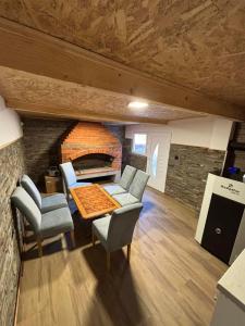 a living room with a table and chairs and a fireplace at Apartman Miljanic in Vlasenica
