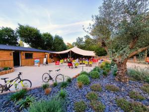 two bikes parked in a garden with a tent at Camping Saint Laurent in Ploemel