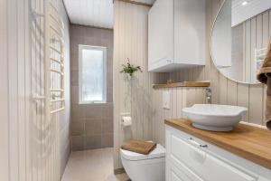 a white bathroom with a sink and a toilet at TV1705-Bindslev-Nordkapvej-4 in Tversted