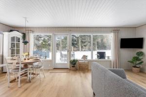 a living room with a table and chairs and a television at TV1705-Bindslev-Nordkapvej-4 in Tversted