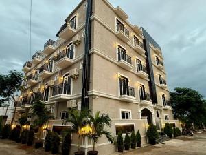 a large white building with plants in front of it at Haraa Suites Tiruvannamalai in Tiruvannāmalai
