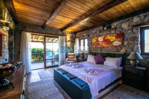 a bedroom with a bed with towels on it at Kaya Koy Deluxe Villas Fethiye in Fethiye +25 photos