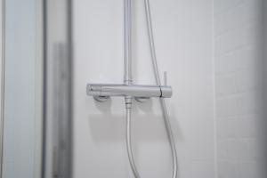 a shower head in front of a mirror at Judería Suite Jaén in Jaén +34 photos