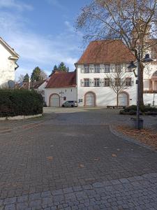 a white building with a red roof and a street at Casa Stetten in Lörrach