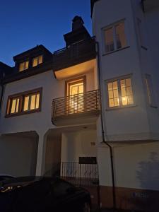 a large white house with its lights on at Casa Stetten in Lörrach +5 photos