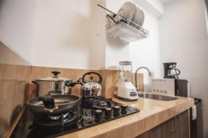 a kitchen with a stove with a pot on it at Florez de la Villa Apartments & Suites in Cusco
