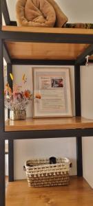 a shelf with a picture and a basket on it at Florez de la Villa Apartments & Suites in Cusco