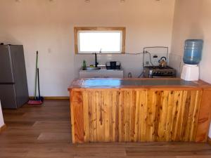 a kitchen with a wooden counter top in a room at Rincon del desierto lodge in Punta de Choros