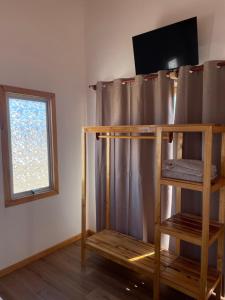 a bunk bed in a room with a window at Rincon del desierto lodge in Punta de Choros