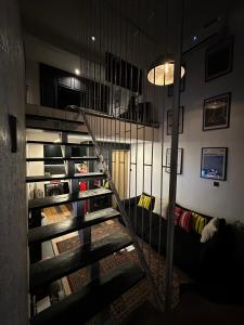 a spiral staircase in a living room with a couch at The Hive Apartments - The Forge Unit in Lagos