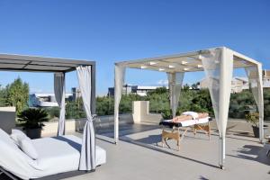 a person laying on a bed on a roof at Fiorentinos Villa in Tragaki